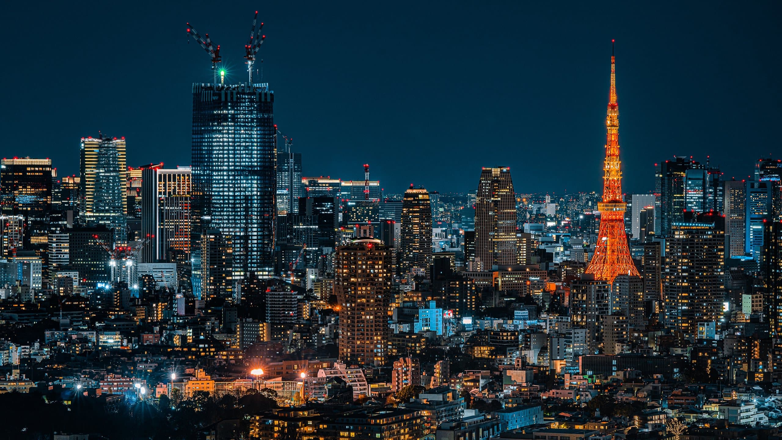 Tokyo Tower lit up over the city at night